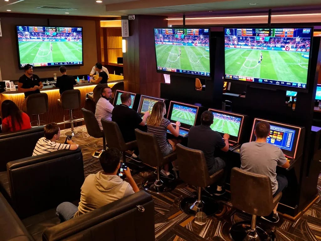 Bsport enthusiasts engaging in live sports betting at a modern casino's vibrant betting area.